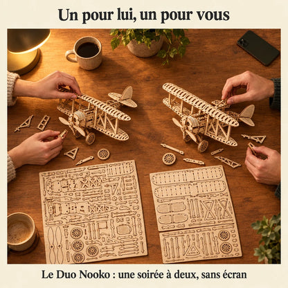 Two people building a NOOKO kit side by side, a screen-free evening