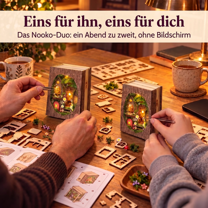 Ein Erwachsener und ein Teenager bauen je eine Waldlichtung-Zuflucht am Schreibtisch