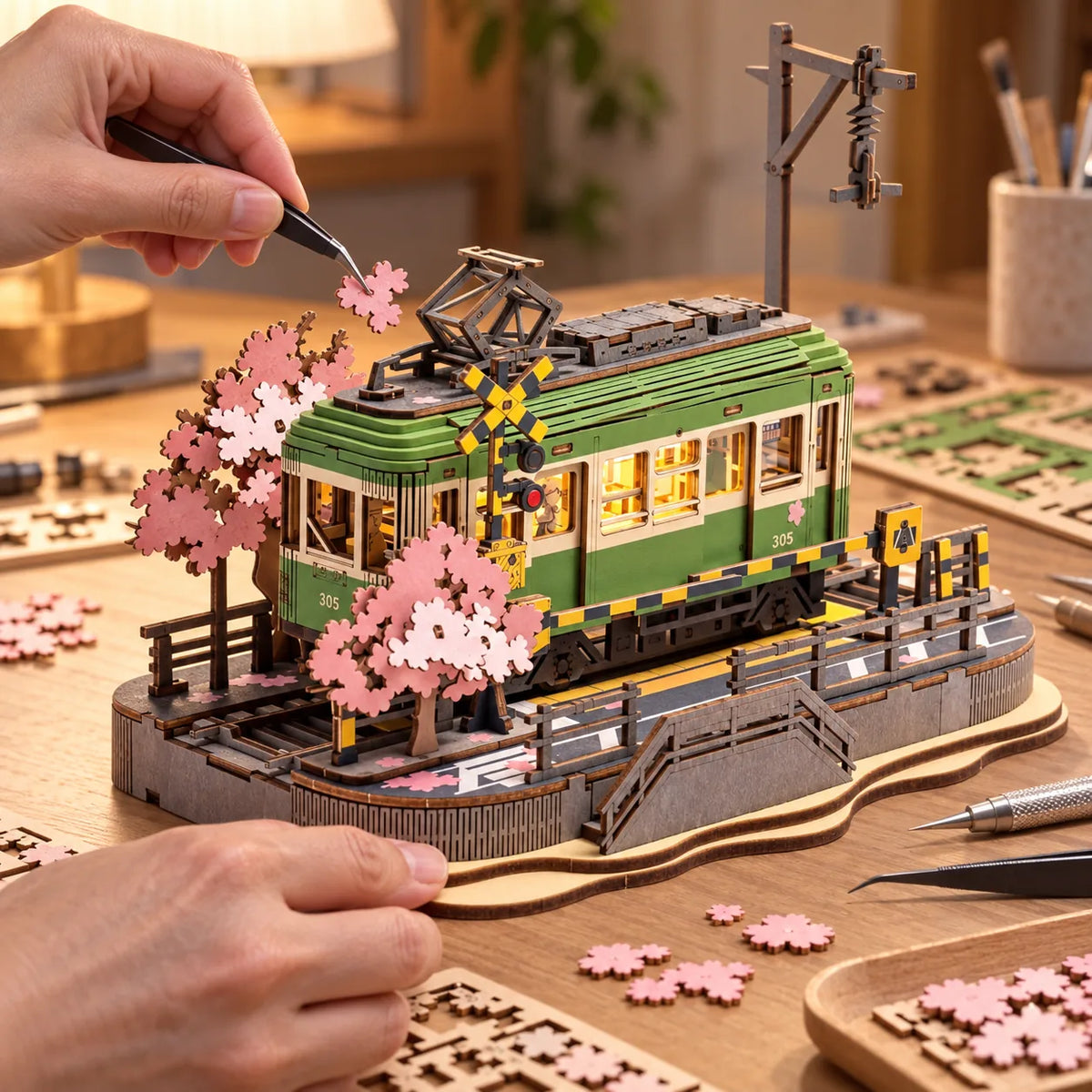 Pose des fleurs de cerisier sur la maquette Tram Sakura